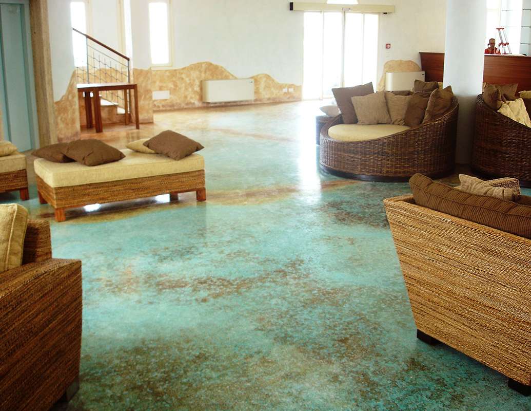 Teal acid-stained concrete living room floor